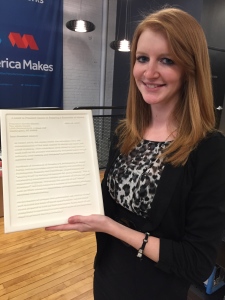 Ashley Martof holds the letter that she designed and printed for President Obama.